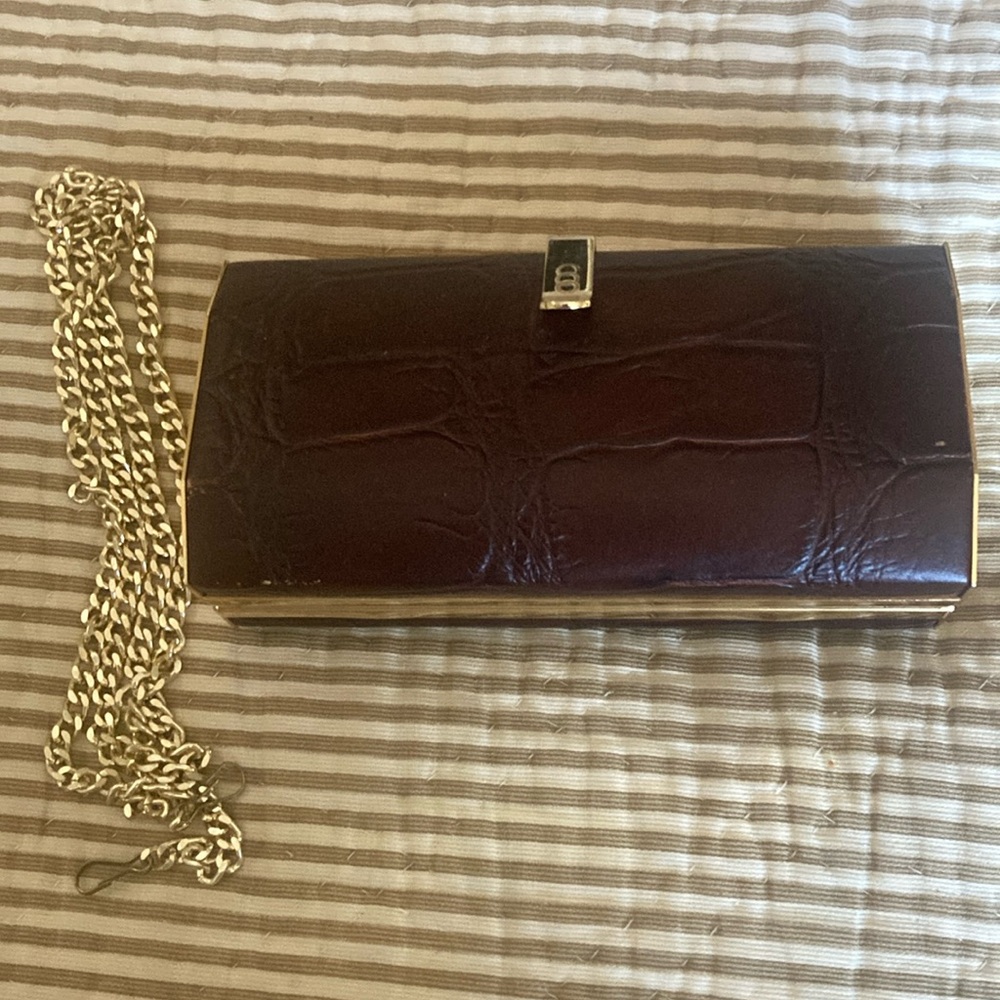 Brown leather clutch with removable gold chain for over the shoulder strap